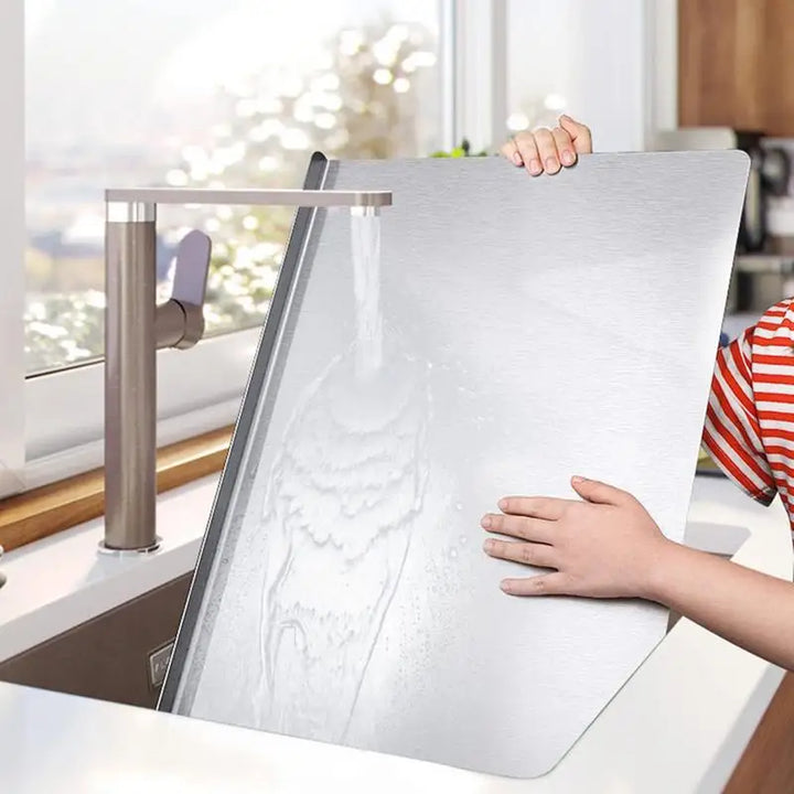 Stainless steel chopping board with non-slip silicone pads, sleek finish, ideal for meat, fish, veggies slicing.