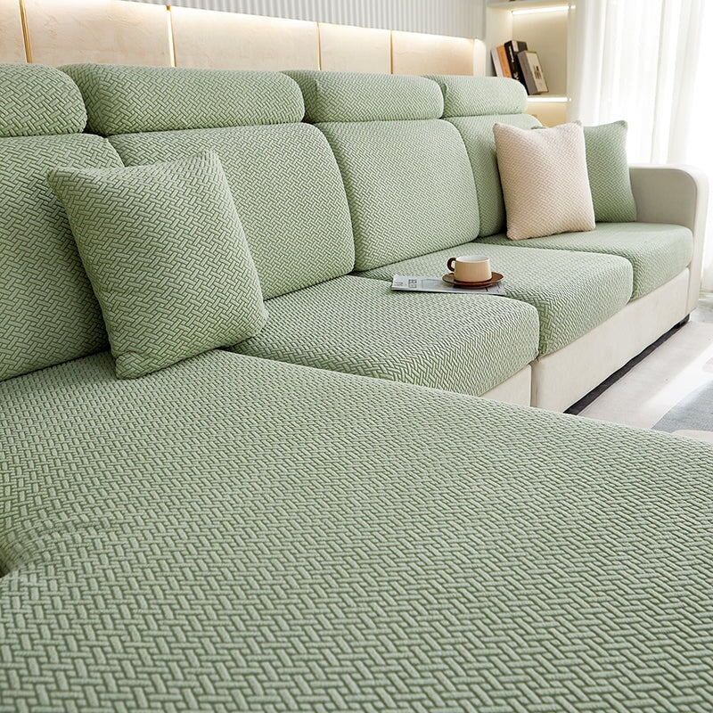 Stretchable sectional sofa cover in vibrant tangerine, snug fit, durable fabric, ideal for home decor and furniture protectio