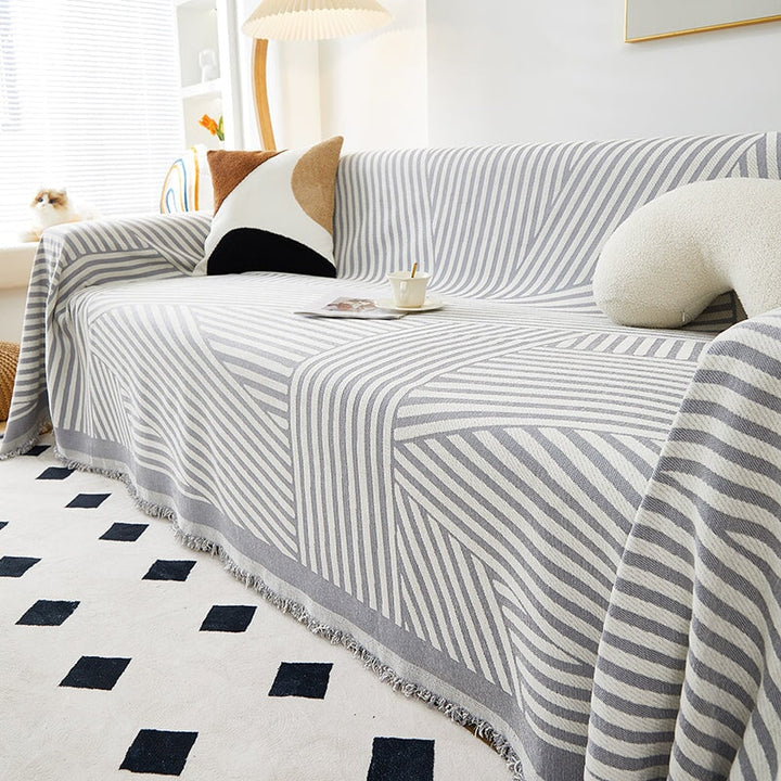 "Striped sofa throw cover, durable stretchable fabric, minimalist pattern, elevates living space, protects against spills."