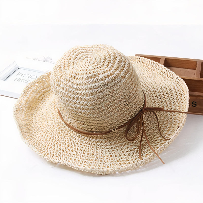 Women's foldable wide-brim straw hat in white, beige, blue, or pink for summer, beach, or resort wear.