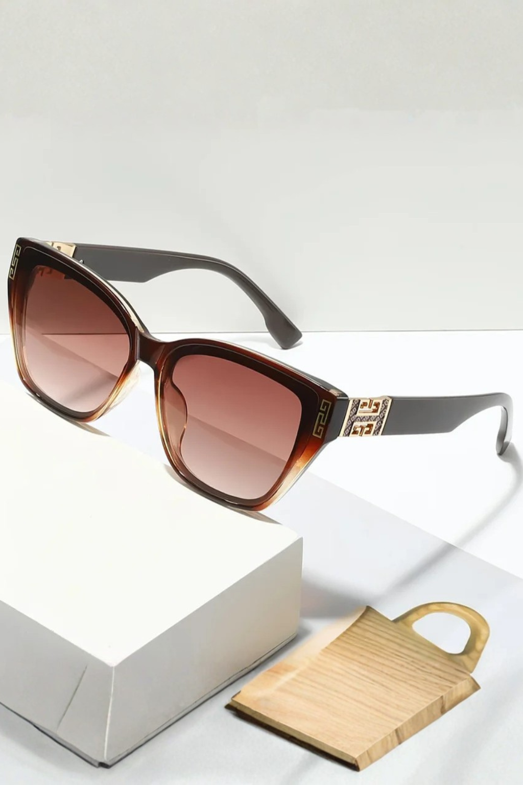 Chic women's cat eye sunglasses, gold temples & gradient lenses. Offers stylish UV protection.