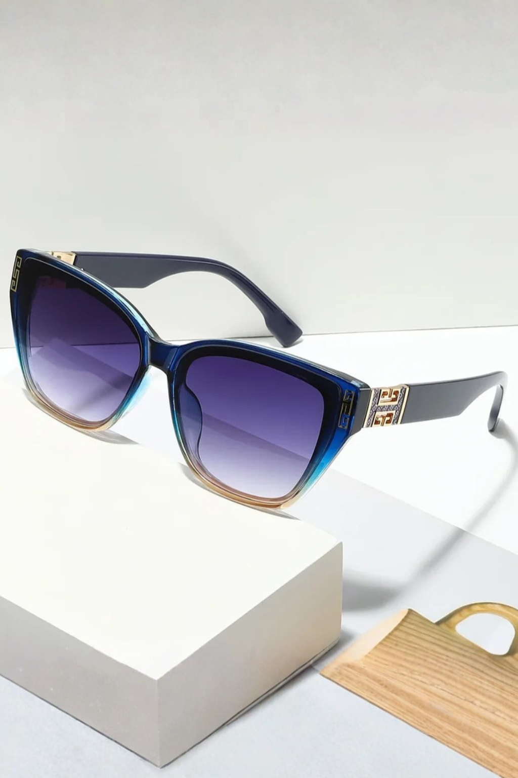 Women's cat eye sunglasses with clear vision gradient lenses & elegant gold detail. UV protected.