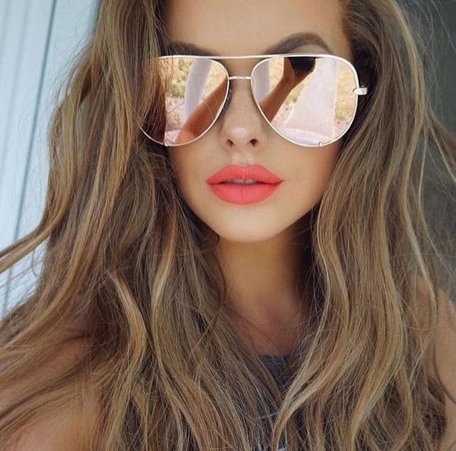Fashionable women's black aviator sunglasses with mirrored lenses, a stylish and trendy eyewear choice.