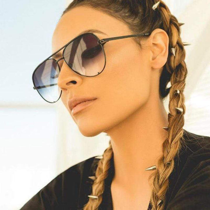 Classic aviator sunglasses for women featuring stylish mirrored lenses. Fashionable and trendy eyewear.