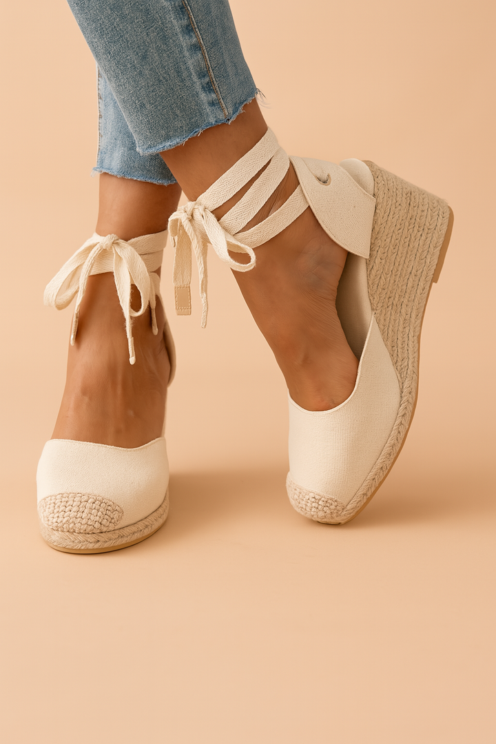 Stylish women's wedge sandals with espadrille sole & adjustable ankle ties. Perfect for summer casual elegance.