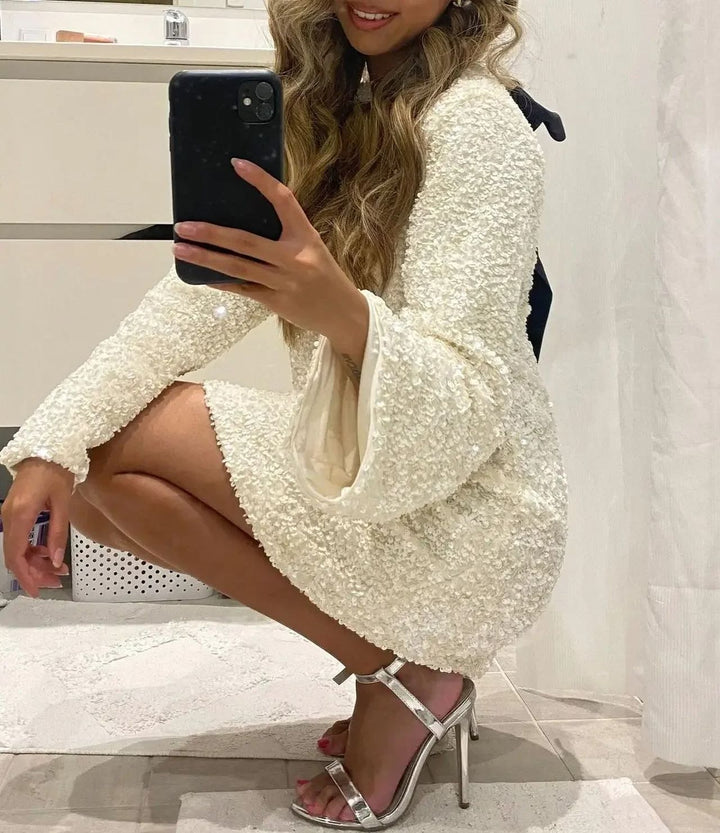 Glamorous knee-length sequin cocktail dress for women, featuring stunning sparkle & back bow.