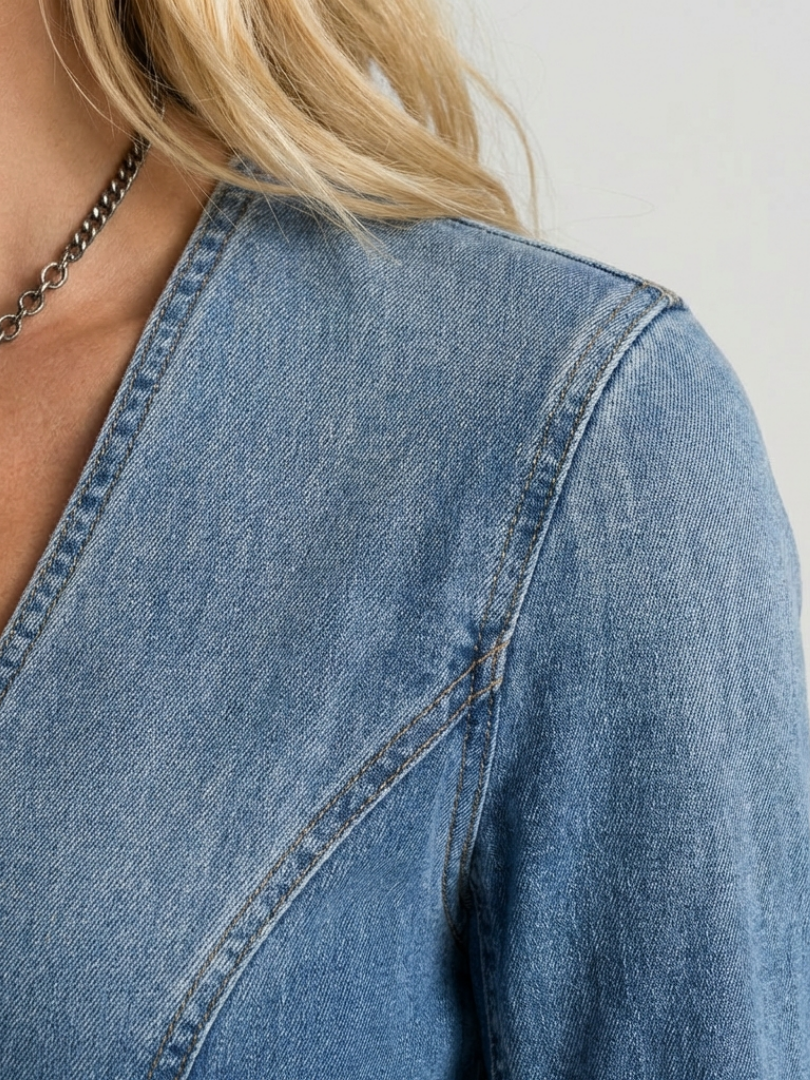 Close-up of a women's flowy maxi dress, showcasing button front detail & soft, comfortable fabric.