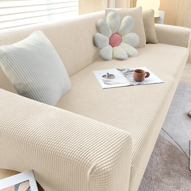 Textured stretch sofa cover in beige, snug fit for sofas, non-slip, adds elegance, protects against spills and wear.