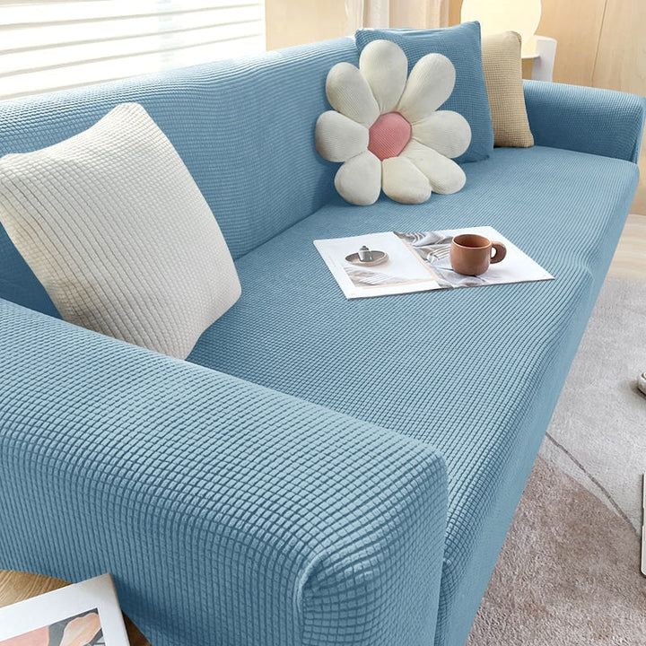 Textured stretch sofa cover in beige, snug fit for sofas, non-slip, adds elegance, protects against spills and wear.