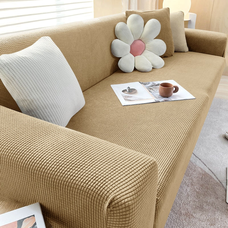 Textured stretch sofa cover in beige, snug fit for sofas, non-slip, adds elegance, protects against spills and wear.