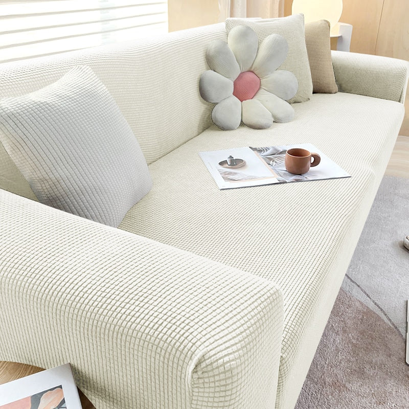 Textured stretch sofa cover in beige, snug fit for sofas, non-slip, adds elegance, protects against spills and wear.