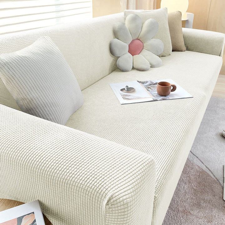 Textured stretch sofa cover in beige, snug fit for sofas, non-slip, adds elegance, protects against spills and wear.
