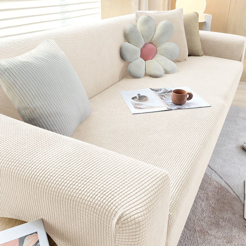 Textured stretch sofa cover in beige, snug fit for sofas, non-slip, adds elegance, protects against spills and wear.