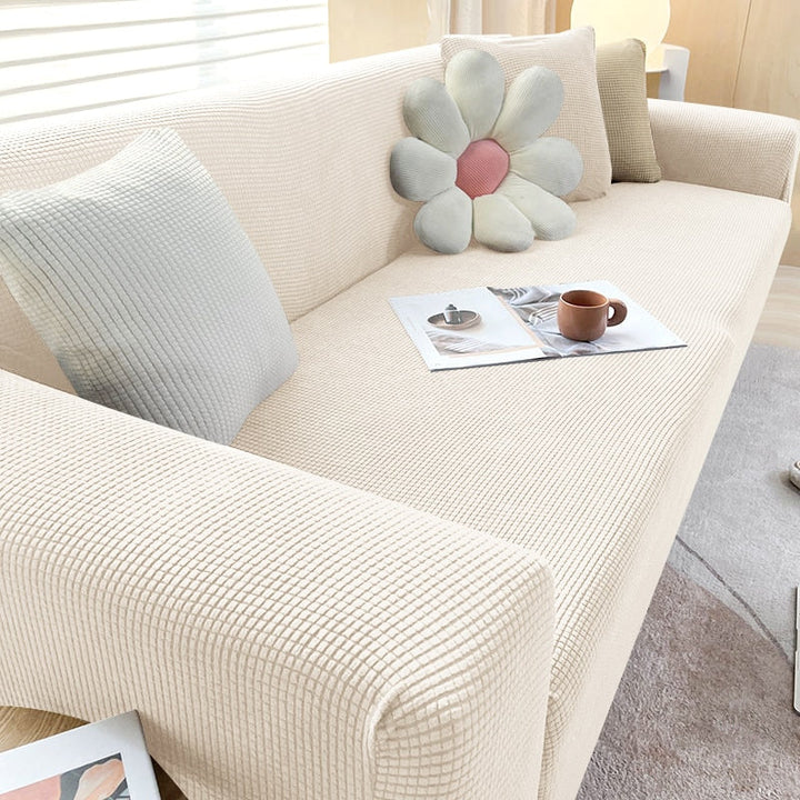 Textured stretch sofa cover in beige, snug fit for sofas, non-slip, adds elegance, protects against spills and wear.
