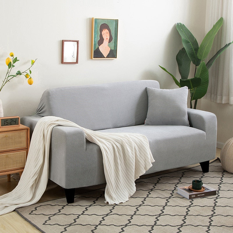 Textured stretch sofa cover in beige, snug fit for sofas, non-slip, adds elegance, protects against spills and wear.