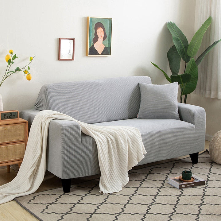 Textured stretch sofa cover in beige, snug fit for sofas, non-slip, adds elegance, protects against spills and wear.
