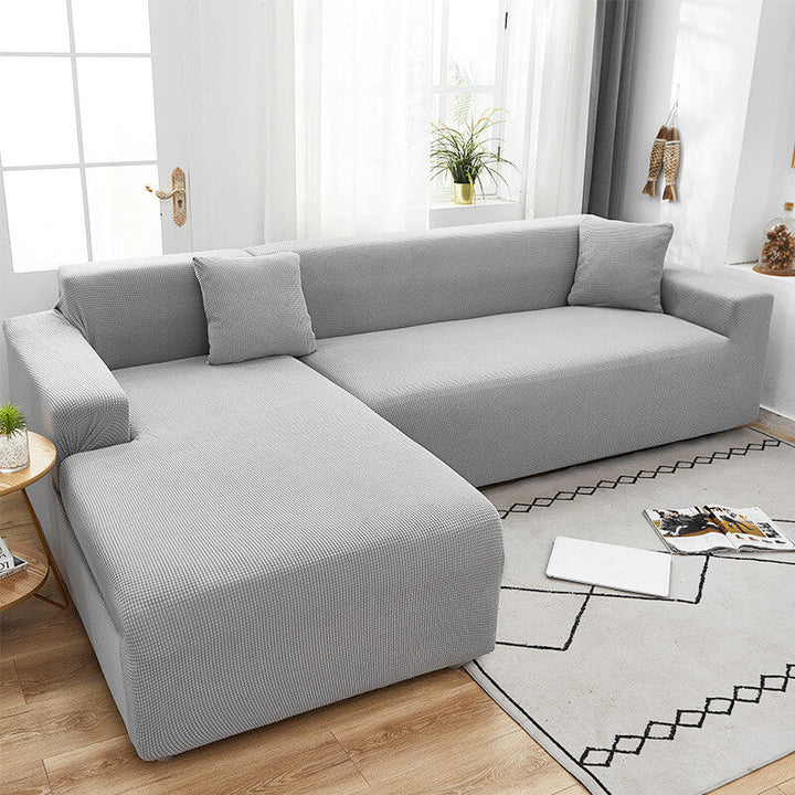 Textured stretch sofa cover in beige, snug fit for sofas, non-slip, adds elegance, protects against spills and wear.
