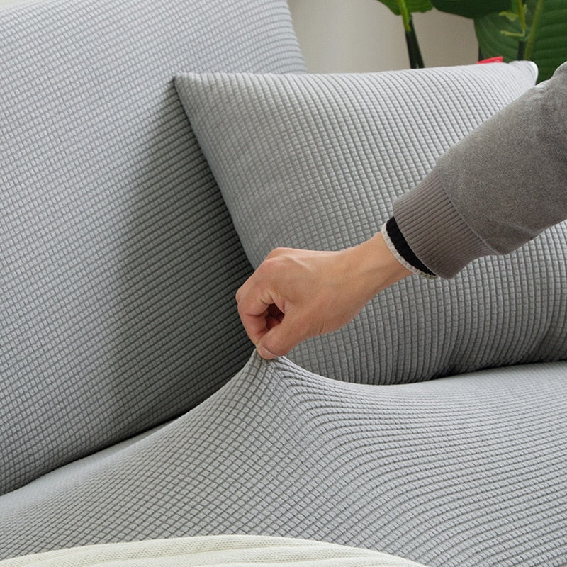 Textured stretch sofa cover in beige, snug fit for sofas, non-slip, adds elegance, protects against spills and wear.