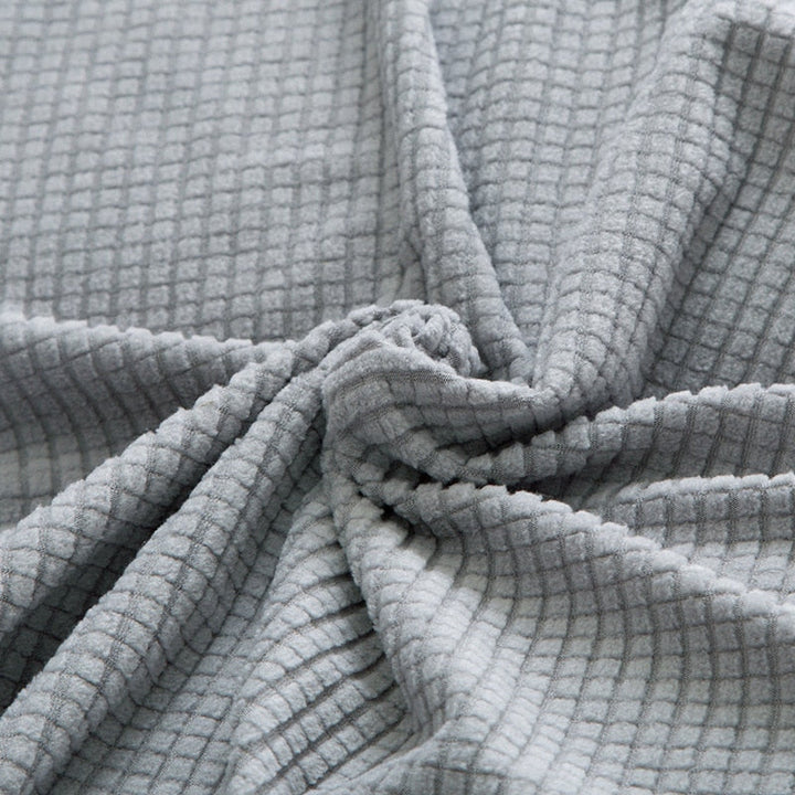 Textured stretch sofa cover in beige, snug fit for sofas, non-slip, adds elegance, protects against spills and wear.
