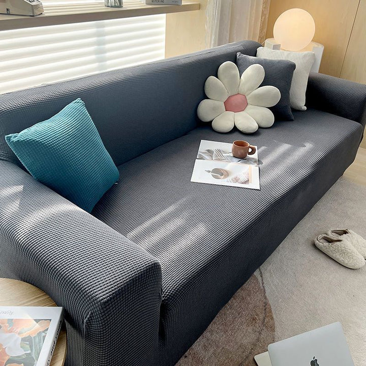 Textured stretch sofa cover in beige, snug fit for sofas, non-slip, adds elegance, protects against spills and wear.