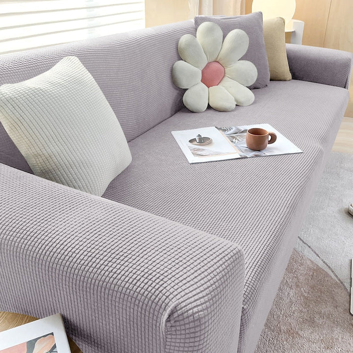 Textured stretch sofa cover in beige, snug fit for sofas, non-slip, adds elegance, protects against spills and wear.
