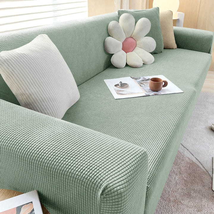 Textured stretch sofa cover in beige, snug fit for sofas, non-slip, adds elegance, protects against spills and wear.
