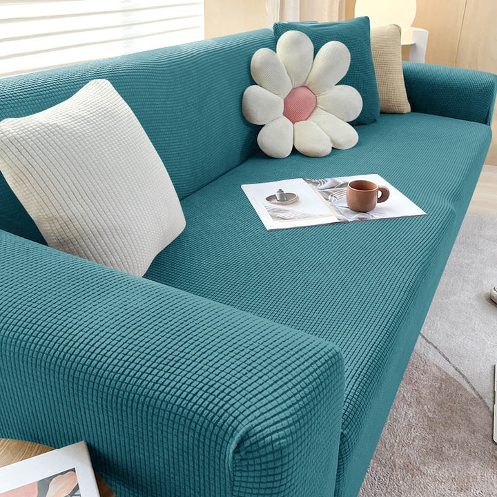 "Textured stretch sofa cover in beige, snug fit for sofas, non-slip, adds elegance, protects against spills and wear."