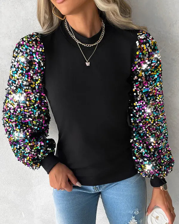 Chic black balloon sleeve blouse with sparkling sequin details, an elegant women's fashion top for versatile wear.