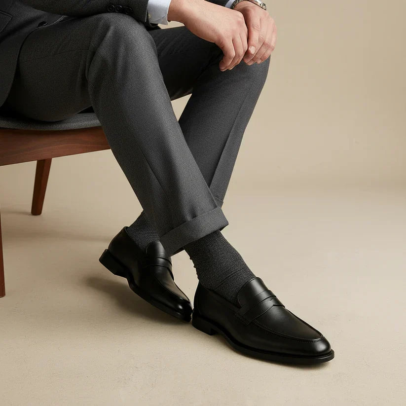Classic black men's penny loafers. Versatile slip-on dress shoes for formal, casual, or business casual outfits.