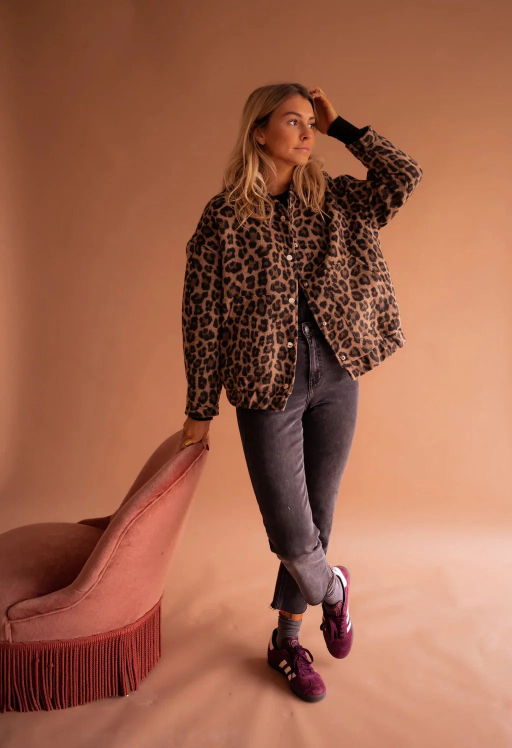 Casual women's leopard print bomber jacket. Trendy brown animal print outerwear featuring a snap button front.