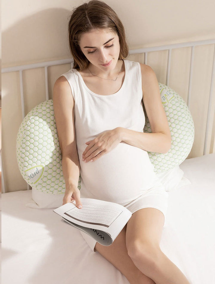 U-Shaped maternity pillow in white, offers full-body support for head, neck, back, belly, and legs with hypoallergenic fabric