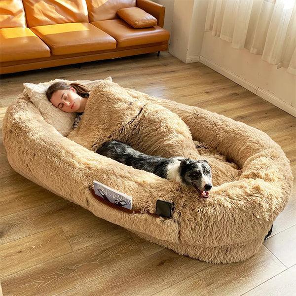 "Ultra-comfy plush lounger for pets and humans, oversized with plush pillow bolsters, dual-layer memory foam, stylish design.