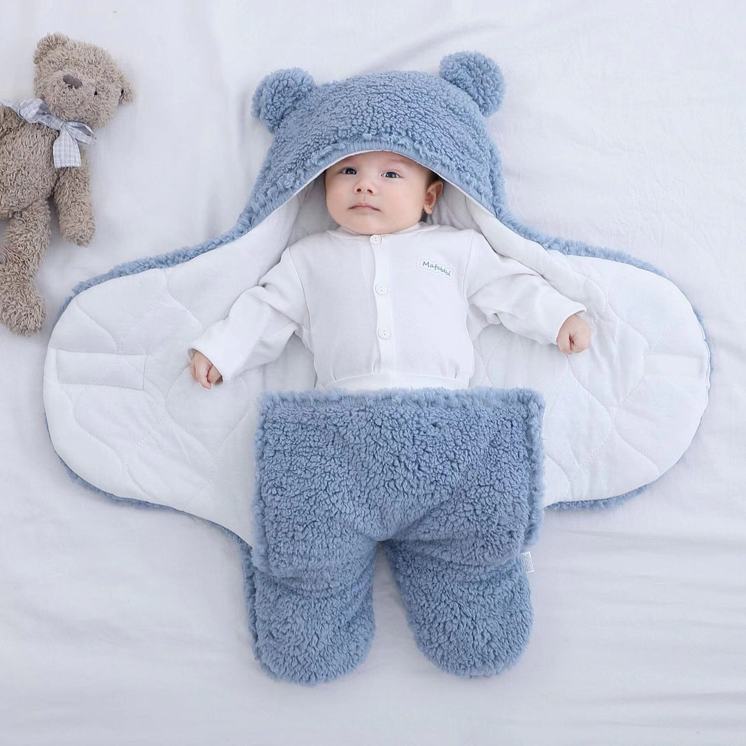 Cozy baby's ultra soft cotton quilted swaddle with bear ears. Plush infant sleeping bag for winter sleep.