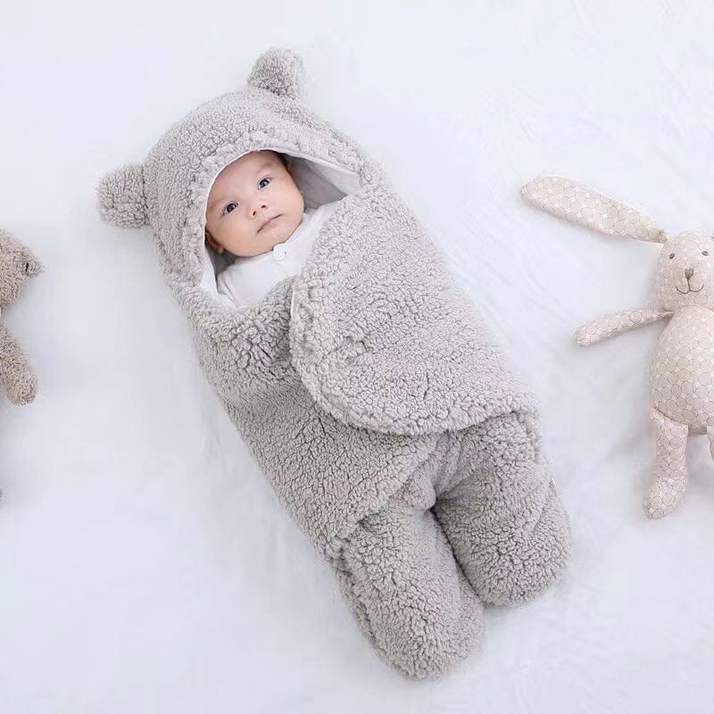 Plush bear ear quilted baby swaddle & sleeping bag. Ultra soft cotton ensures cozy winter sleep for infants.