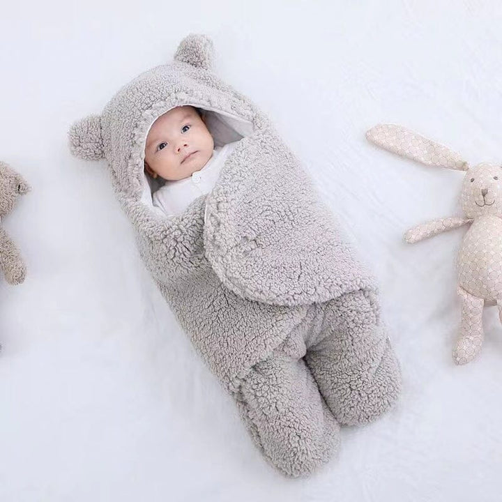 Plush bear ear quilted baby swaddle & sleeping bag. Ultra soft cotton ensures cozy winter sleep for infants.