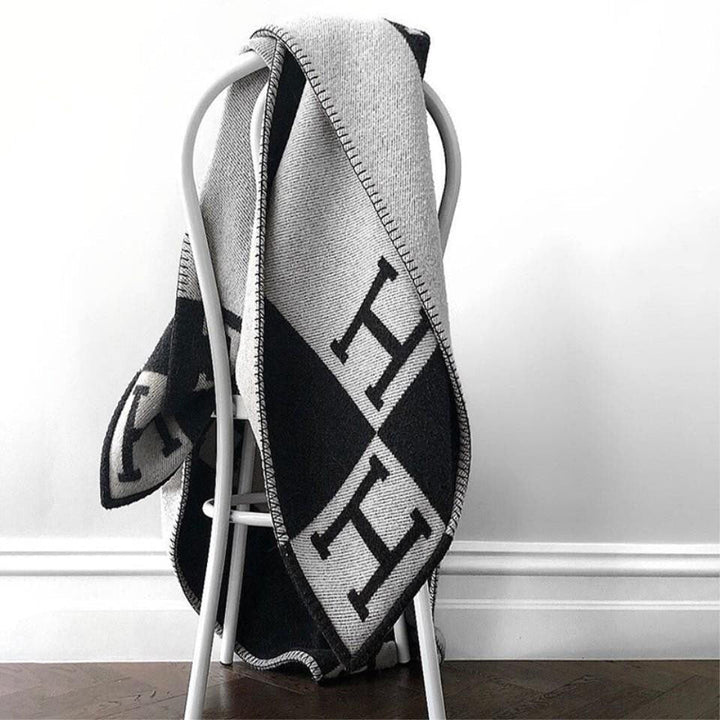 Indulgent wool cashmere throw blanket, providing plush and warm cozy comfort.