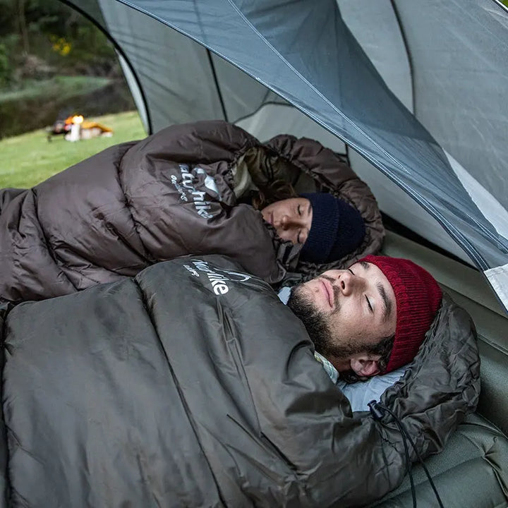 Ultralight women's insulated camping sleeping bag; lightweight, compact, blue fabric ideal for cold-weather adventures.