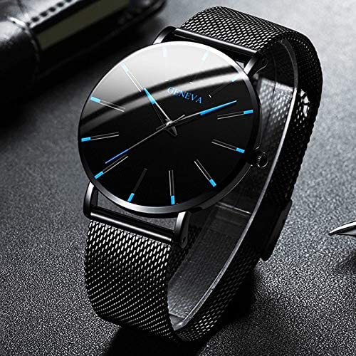Close-up of men's ultra-thin quartz business watch with black dial and leather strap.