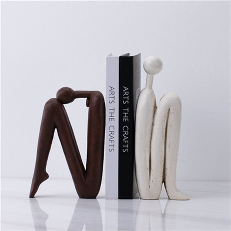 Unique playful bookends in white and brown with artistic modern design for stylish home and office decor shelf.