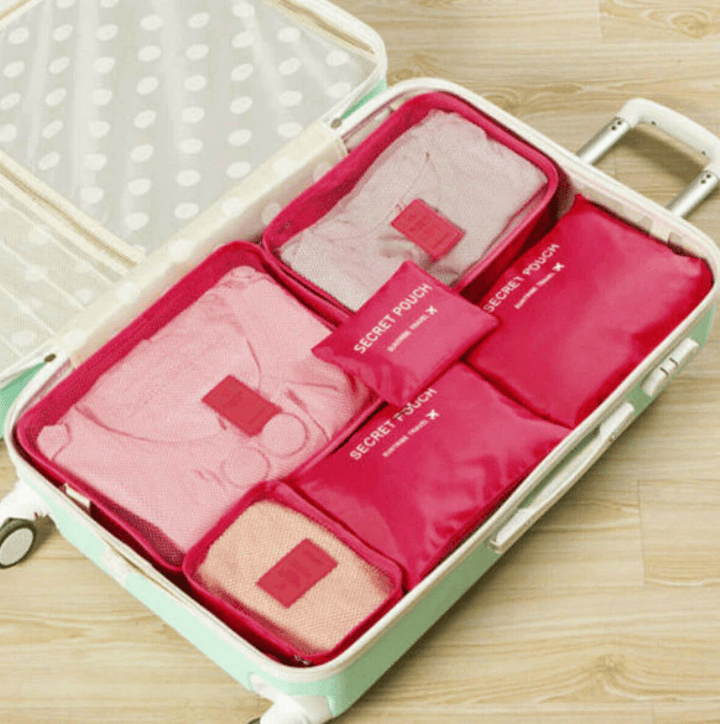 Stacked 12-piece travel organizers, highlighting space-saving and compact storage.