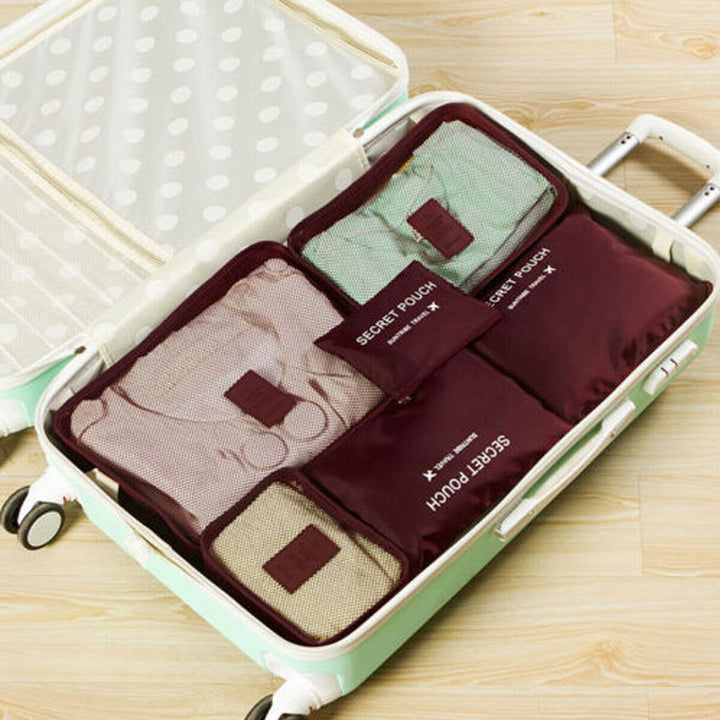 Traveller efficiently packing luggage using the 12-piece 2-set cube bundle.