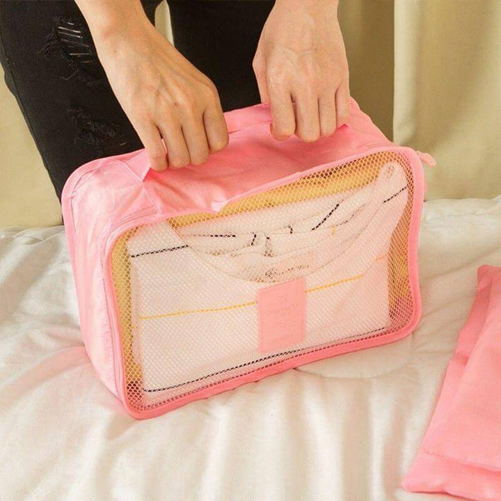 Waterproof travel organizers in use, neatly packed clothes within 2-set cube bundle.