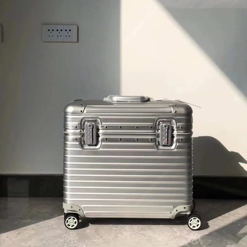 Modern aluminum hardshell suitcase at an airport, ready for durable and elegant vacation travel.
