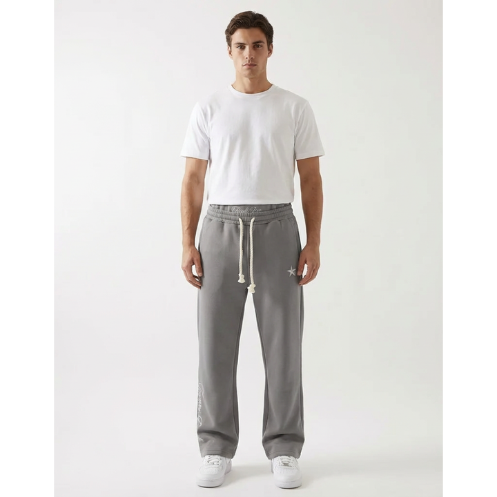 Model wearing grey unisex baggy joggers, showcasing relaxed fit, athleisure style & freedom of movement. Casual joggers.