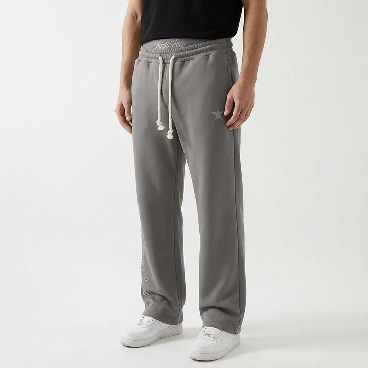 Person relaxing in comfortable unisex baggy joggers, emphasizing leisure pants, ultimate comfort & everyday style.