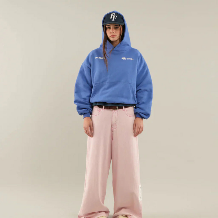 Model enjoying the comfort of a classic unisex pullover hoodie, ideal for loungewear.