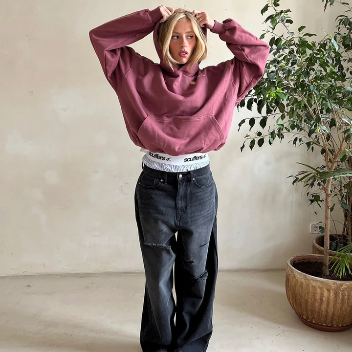 Hanging classic unisex hooded sweatshirt, highlighting its timeless design & comfortable fit.
