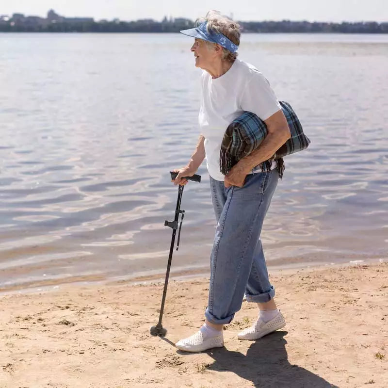 Versatile unisex walking cane, foldable design, with integrated LED light and a secure non-slip base.