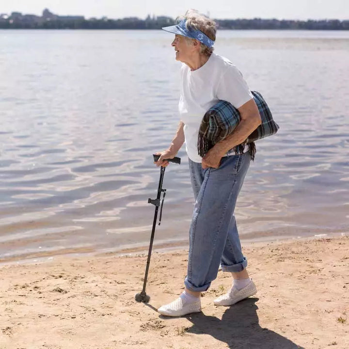 Versatile unisex walking cane, foldable design, with integrated LED light and a secure non-slip base.