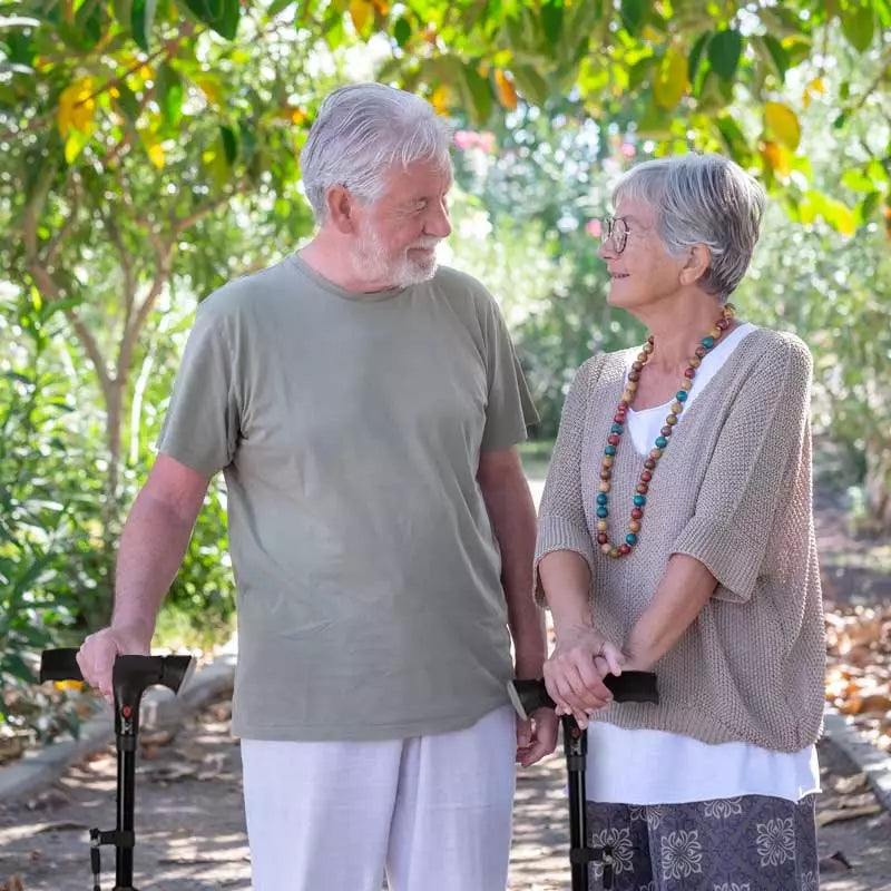 Adjustable walking stick, easily foldable, features an LED light and secure non-slip foot for seniors.